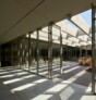 Renovation of Niemeyer Guest House, Tripoli (Lebanon) | Defined by a series of lightweight steel and glass panels registering the ceiling's rhythmic structural grid, the new flexible partition allows for all functions to seamlessly connect to each other and to the central courtyard beyond. | © Aga Khan Trust for Culture / Cemal Emden (photographer)